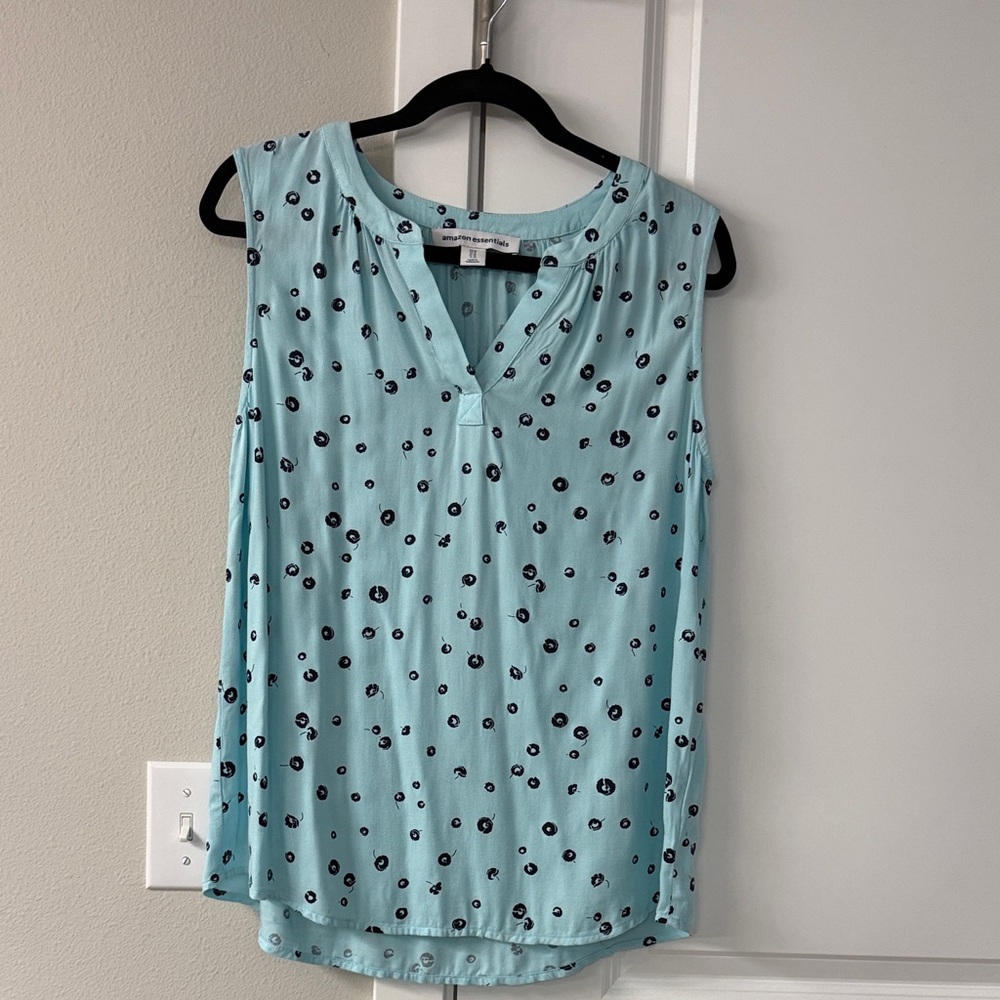 Sleeveless Top - Light Blue with darker blue flower print.  Higher in front.